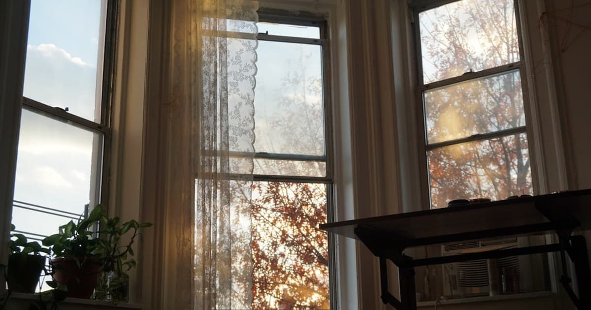 a room with two windows and a table