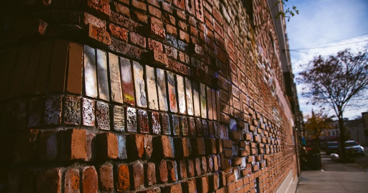 a brick wall with many different colored bricks on it
