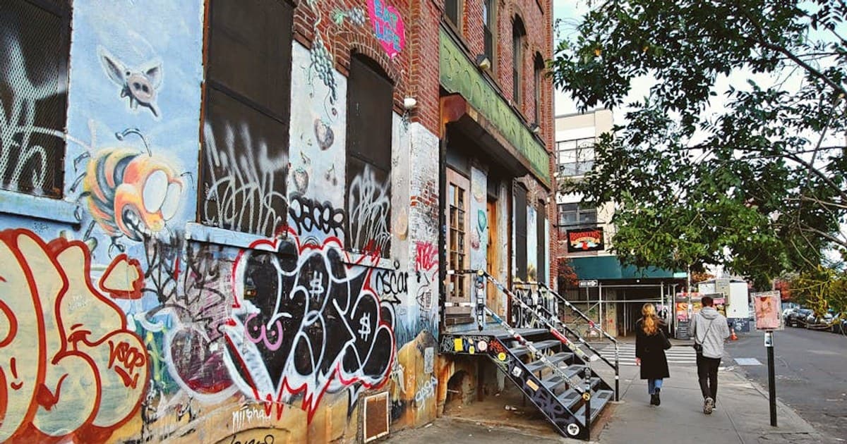 Explore vibrant graffiti art and urban culture in a Brooklyn alleyway.