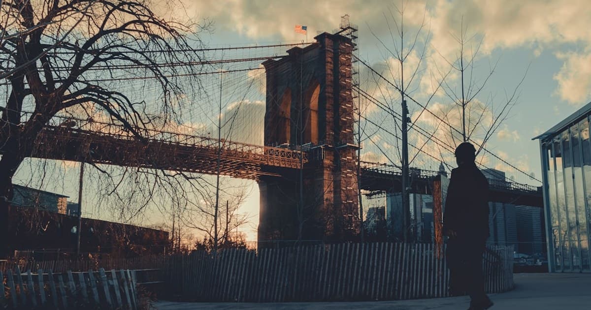 Man standing next to a bridge