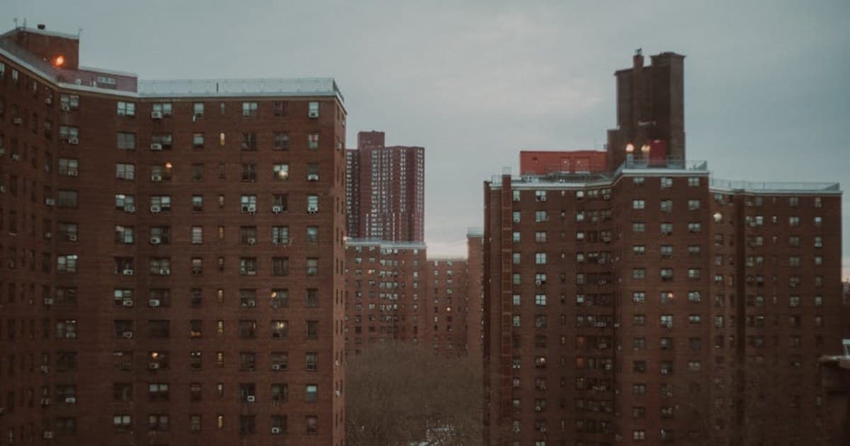Urban New York City apartment buildings at dusk, showcasing winter ambiance.