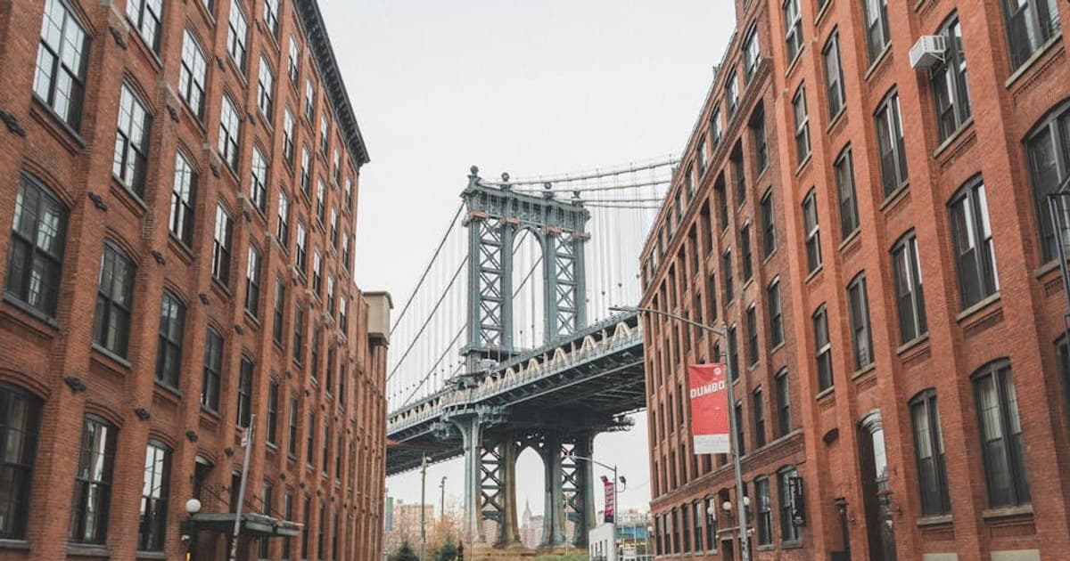Scenic view of the Manhattan Bridge framed by urban architecture in DUMBO, Brooklyn, NYC.