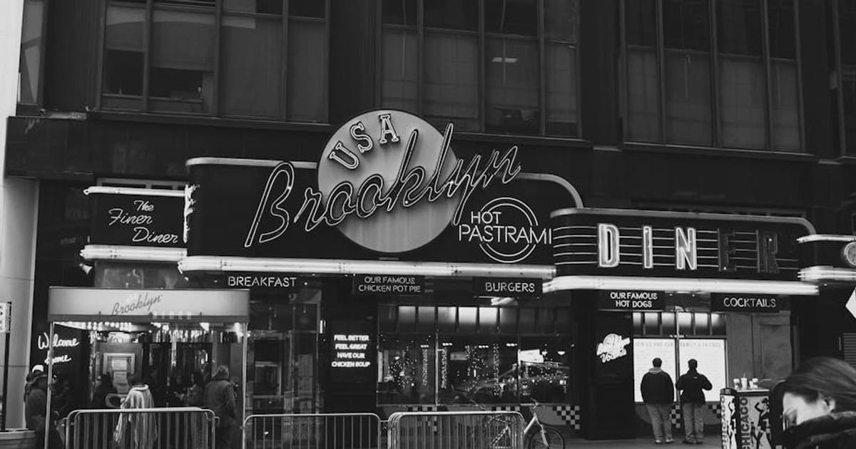 A classic black and white photo of a Brooklyn diner, capturing the essence of urban life in New York City.