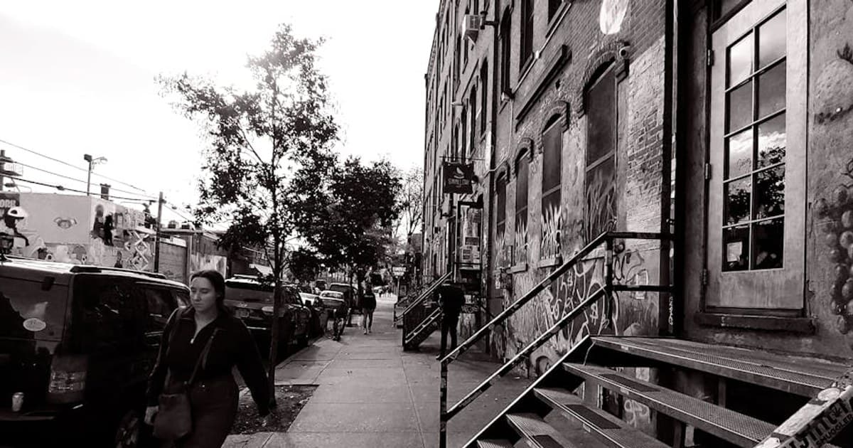 Monochrome street photo showcasing graffiti and architecture in Brooklyn, NY.