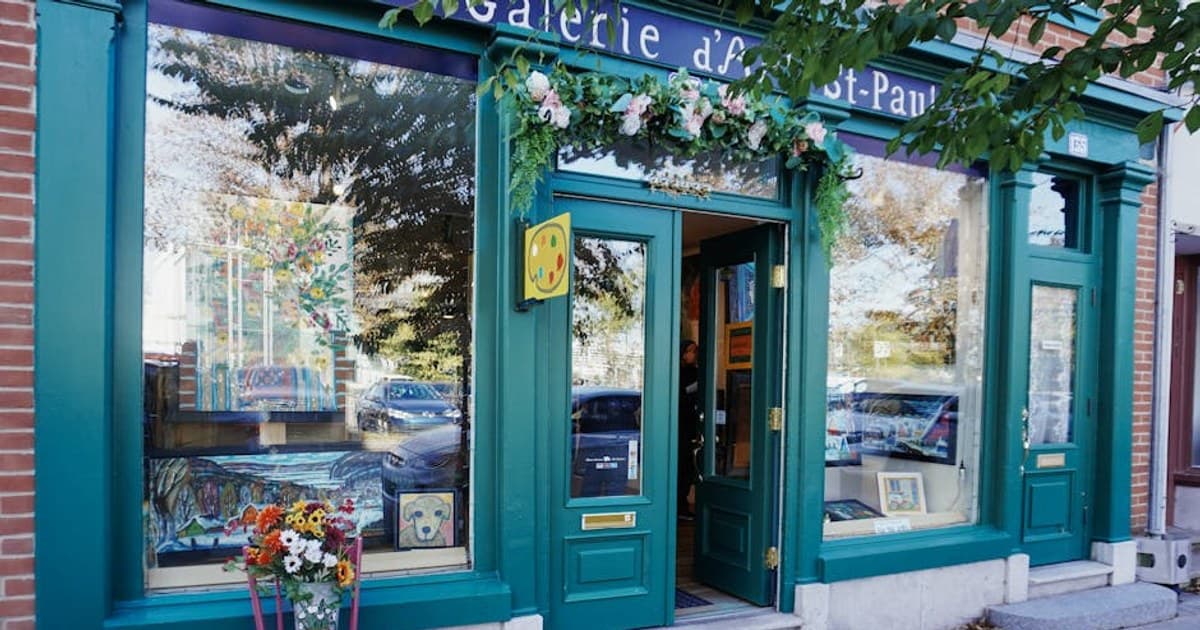 Art gallery entrance with vibrant flowers and artwork on display, showcasing a unique creative vibe.