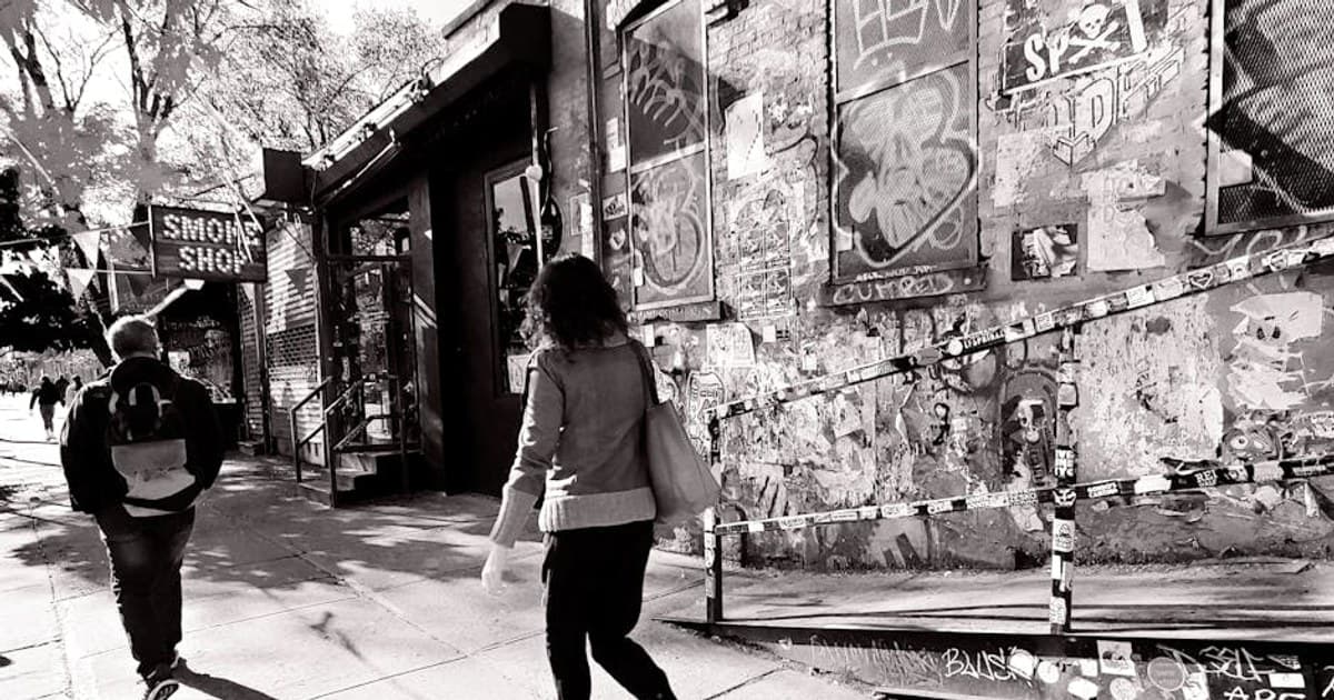 Monochrome street photo capturing the vibrant urban life and graffiti in New York City.