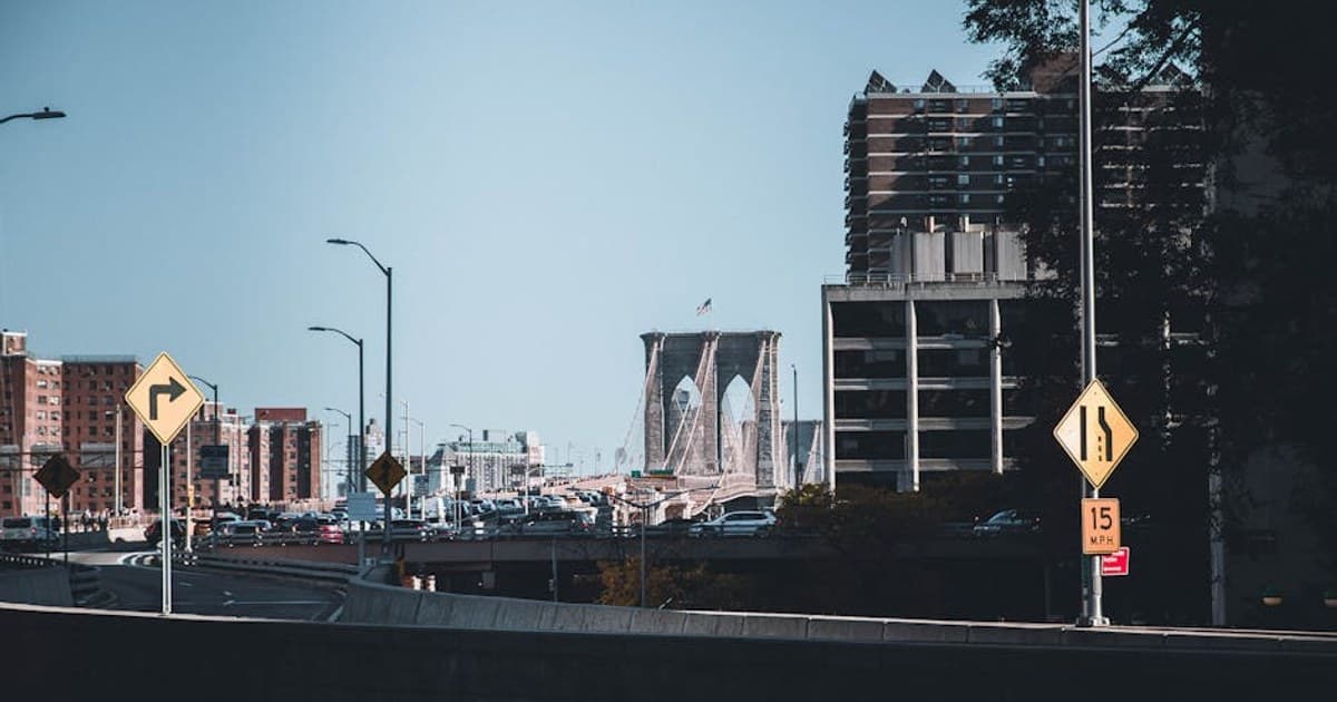 View of the Brooklyn Bridge and city buildings in New York City's urban landscape.