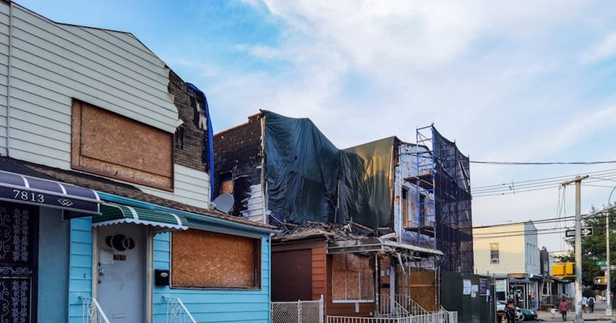 Boarded-up houses showing decay in Queens, New York.