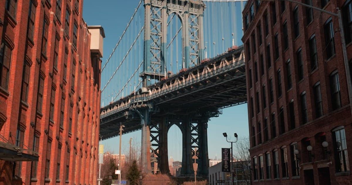 A classic view of the Manhattan Bridge framed by buildings in Brooklyn, New York City.