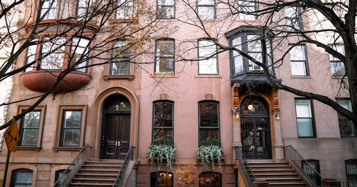 Brownstone buildings in Brooklyn, New York, showcasing autumn charm.