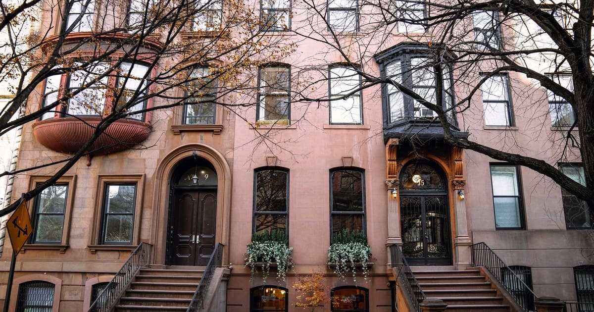 Brownstone buildings in Brooklyn, New York, showcasing autumn charm.